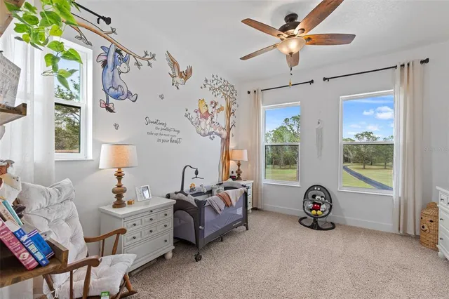 a spacious bedroom with furniture and a window