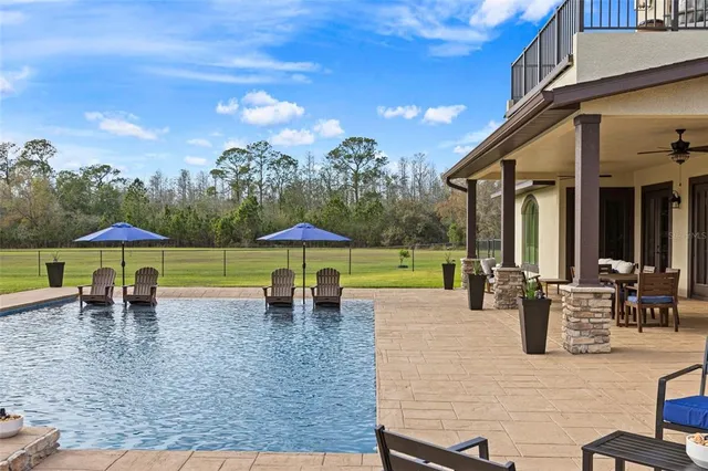 an outdoor space with patio and white umbrellas