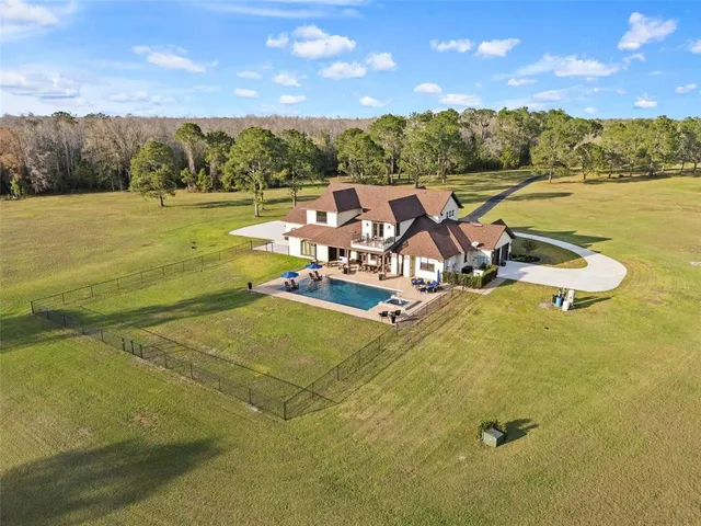 a view of a swimming pool and lake in back