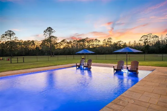 a view of a lake with a table and chairs