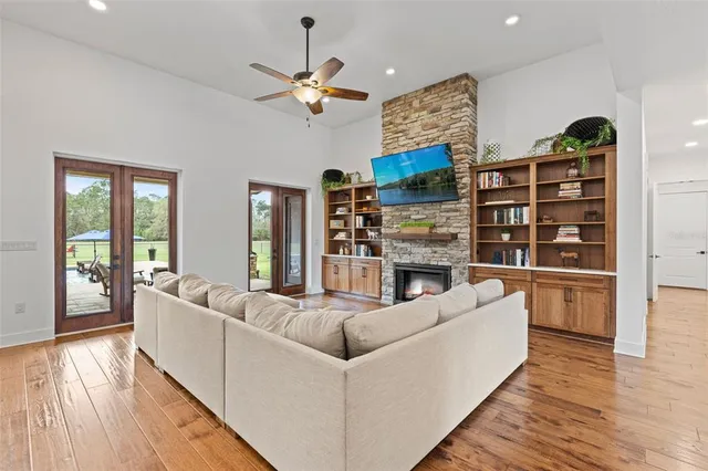 a living room with furniture and wooden floor
