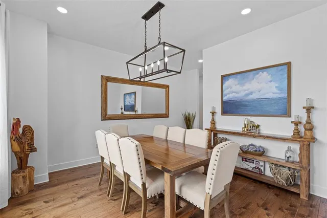 a view of a dining room with furniture wooden floor and a chandelier