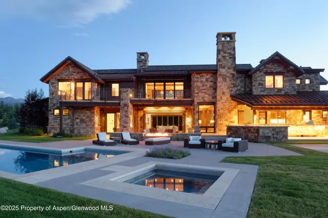 a living room with fireplace furniture and a large window