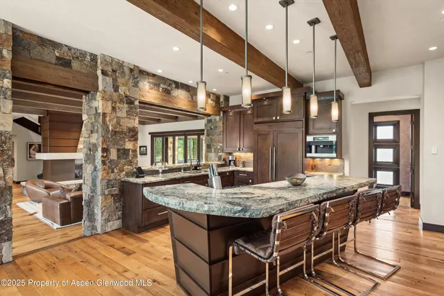 a living room with furniture and floor to ceiling windows