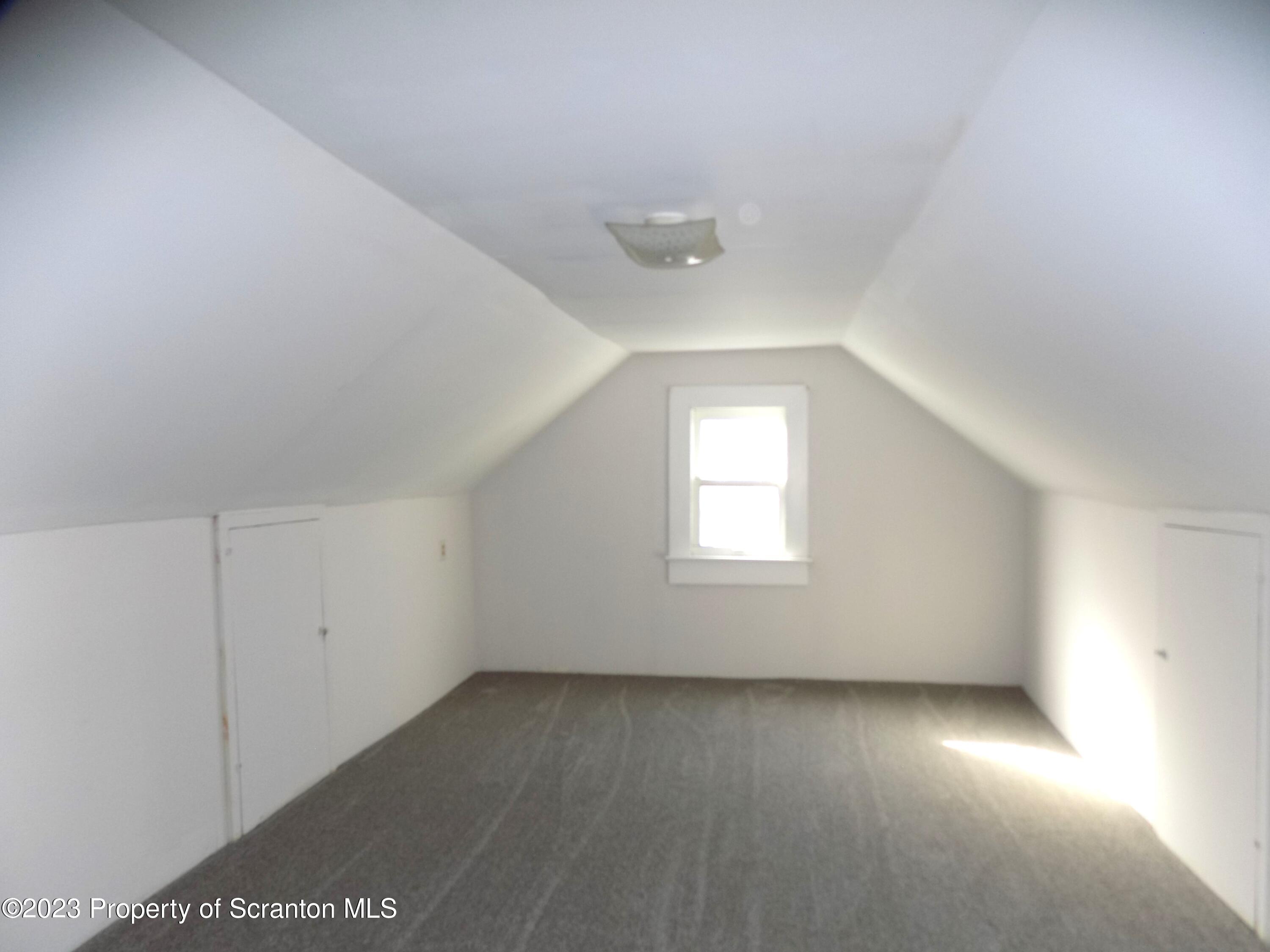 137 Pine Street, Unit 1 Throop, PA 18512 - Photo 12 of 16 an empty room with a window