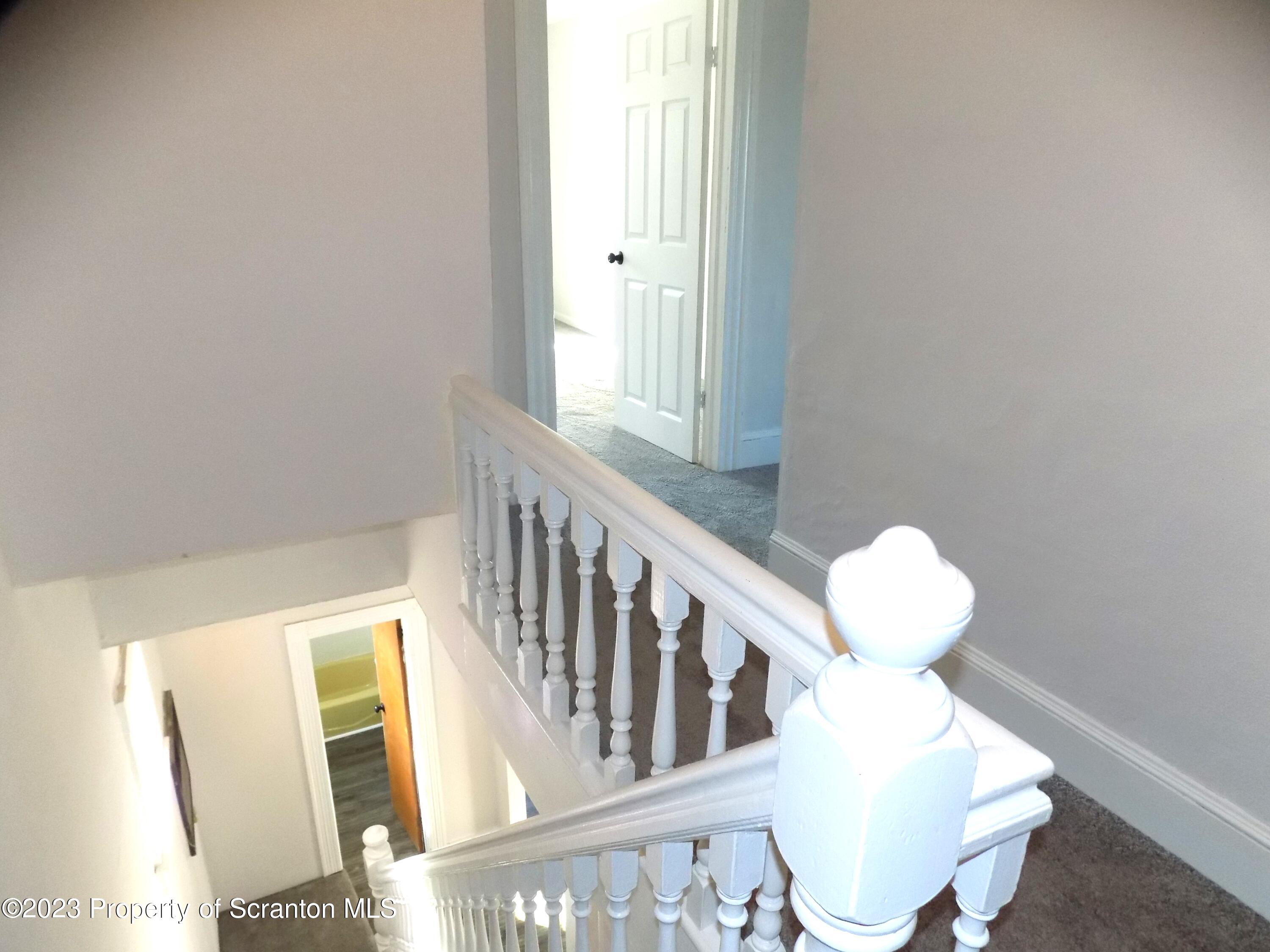137 Pine Street, Unit 1 Throop, PA 18512 - Photo 13 of 16 a view of entryway with wooden floor