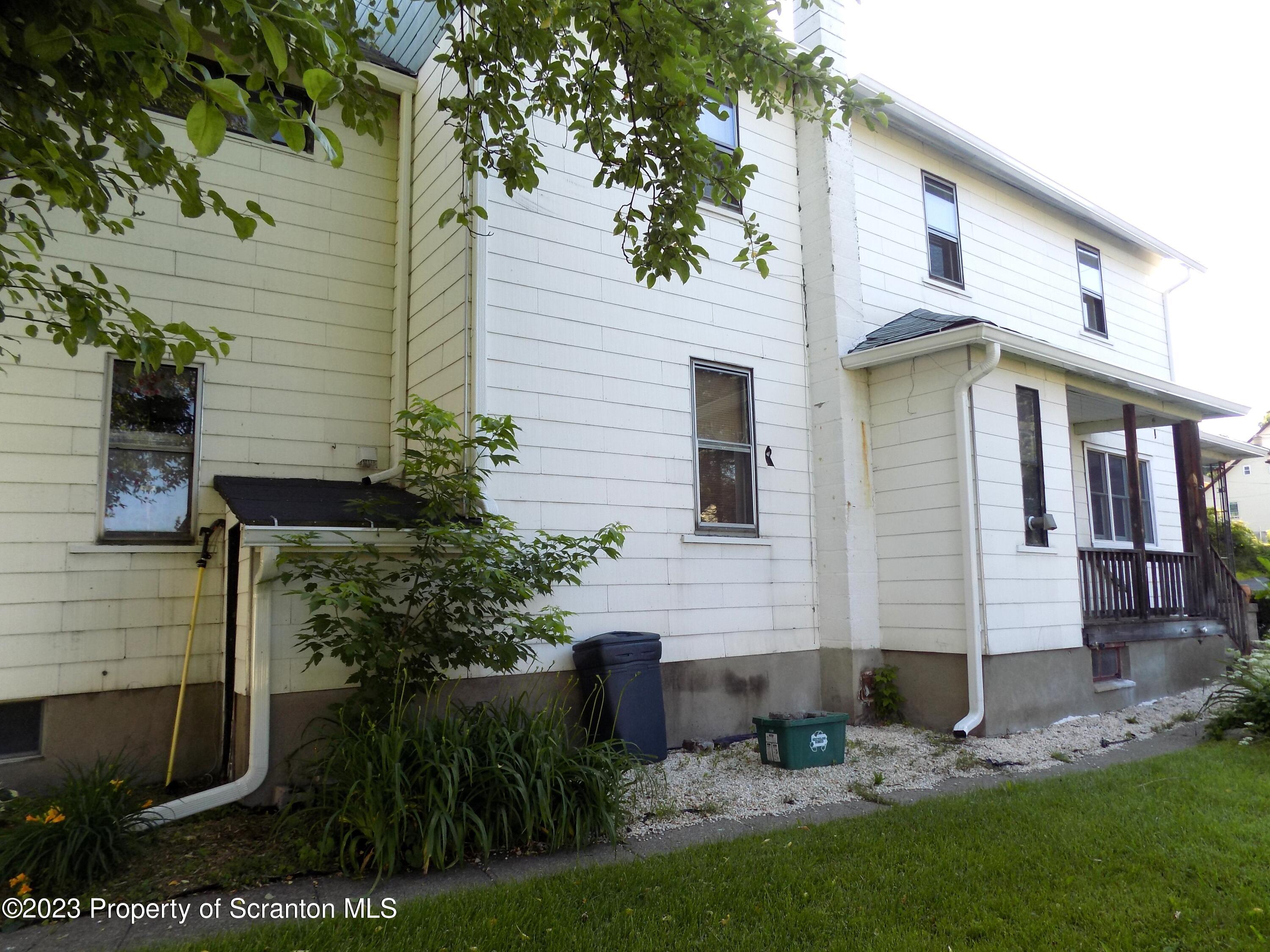 137 Pine Street, Unit 1 Throop, PA 18512 - Photo 15 of 16 a front view of a house with garden