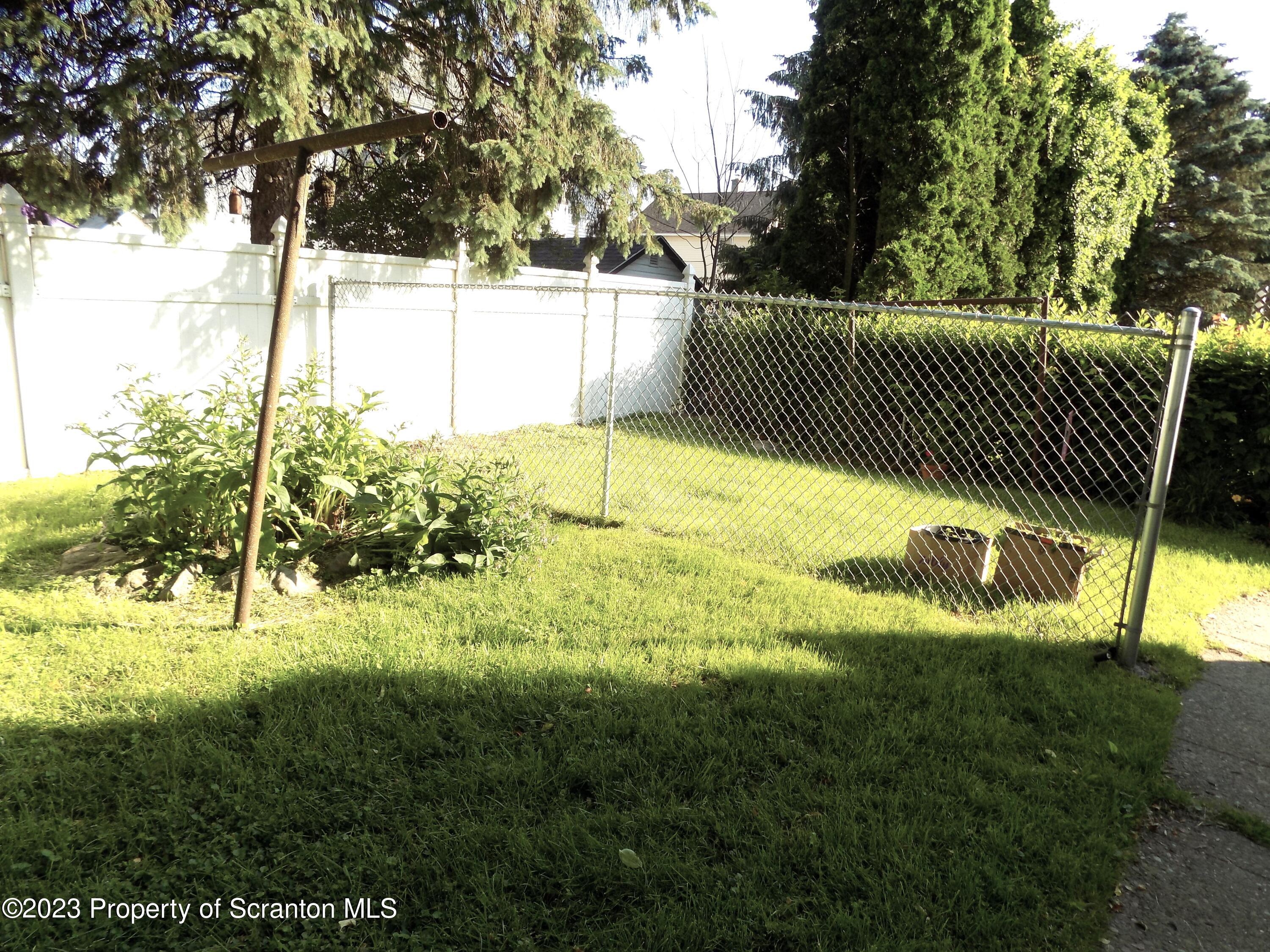 137 Pine Street, Unit 1 Throop, PA 18512 - Photo 16 of 16 a view of a yard with plants and trees
