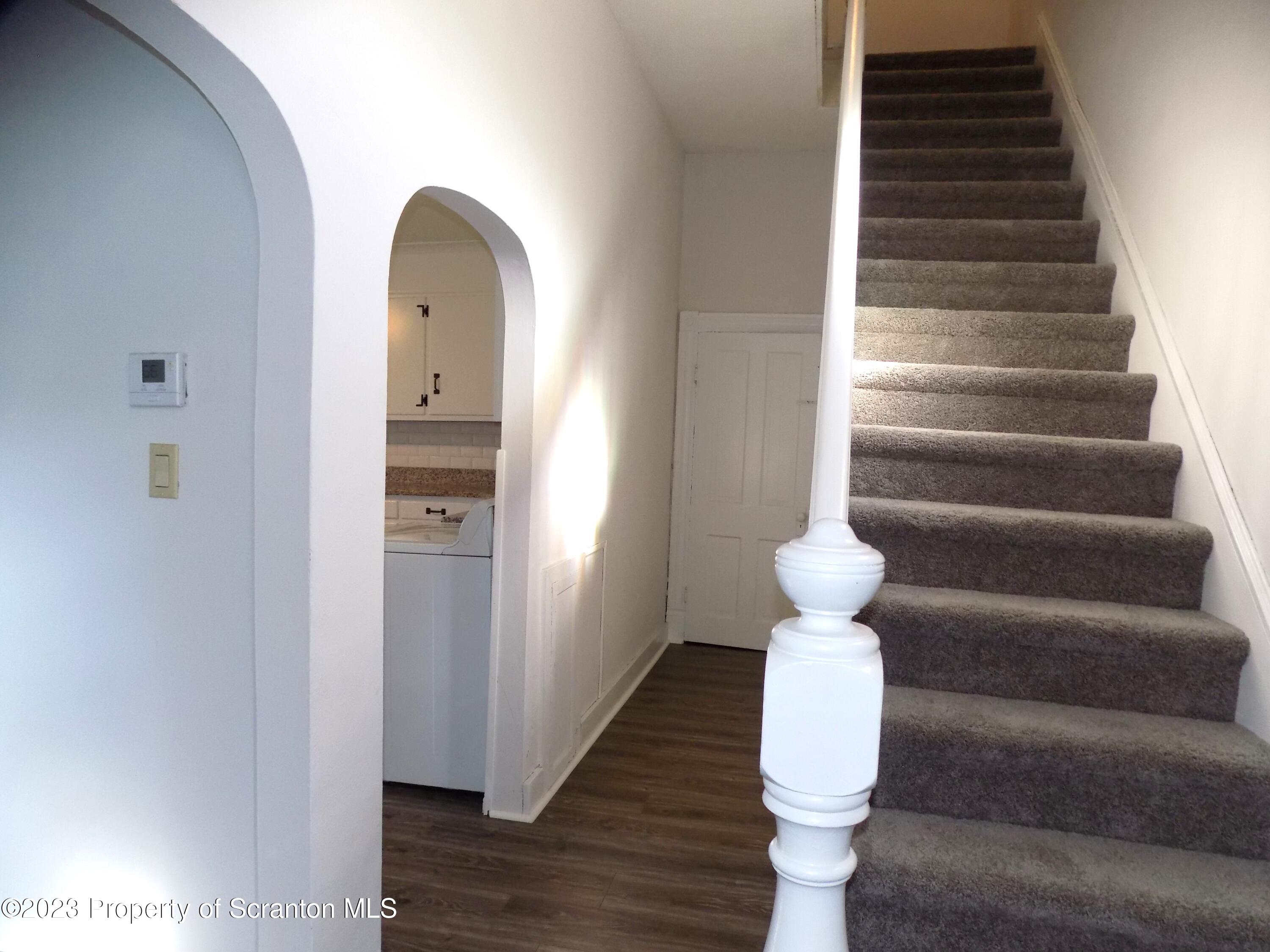137 Pine Street, Unit 1 Throop, PA 18512 - Photo 7 of 16 a view of entryway and hall with wooden floor