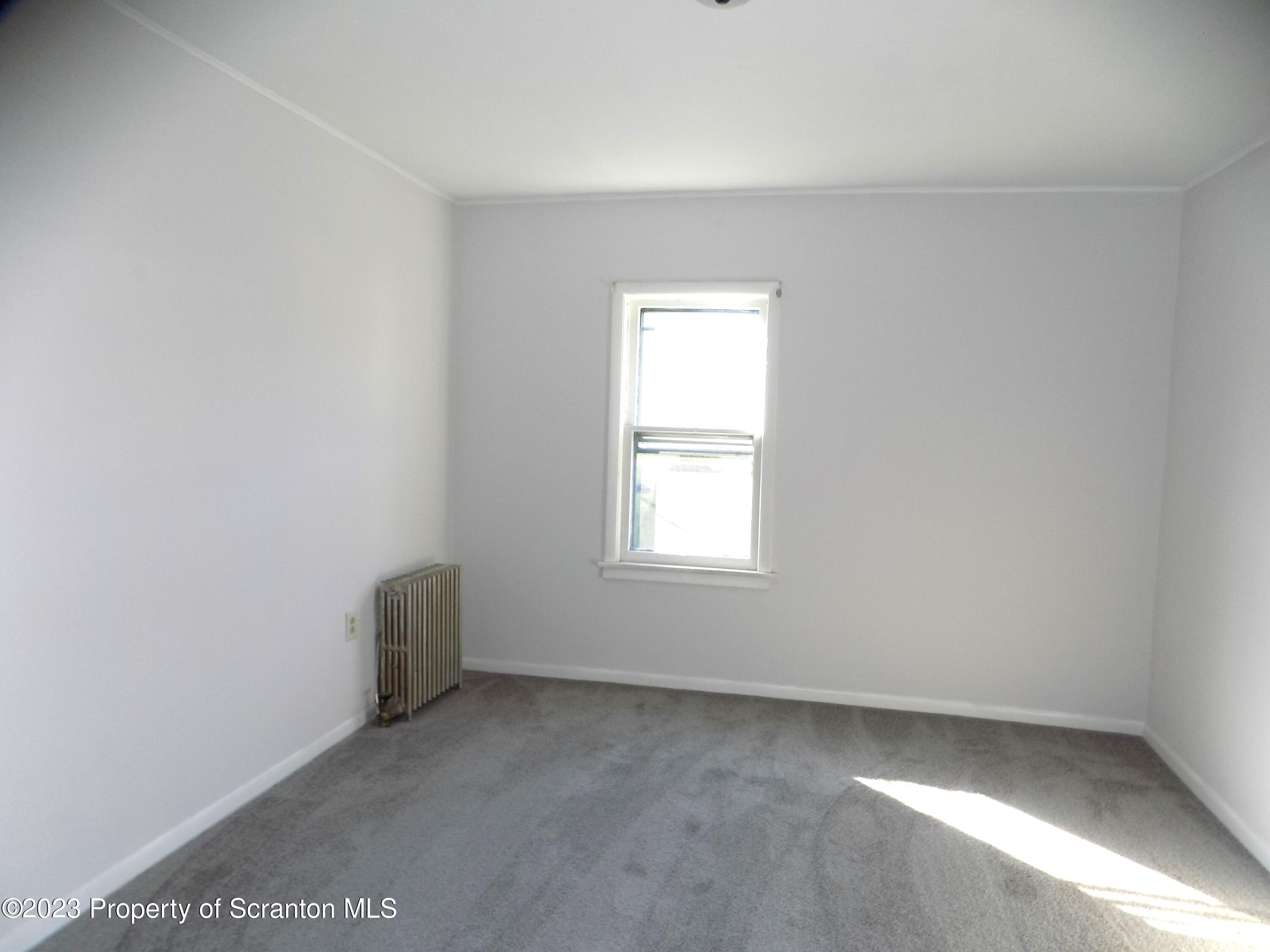 137 Pine Street, Unit 1 Throop, PA 18512 - Photo 8 of 16 an empty room with a window