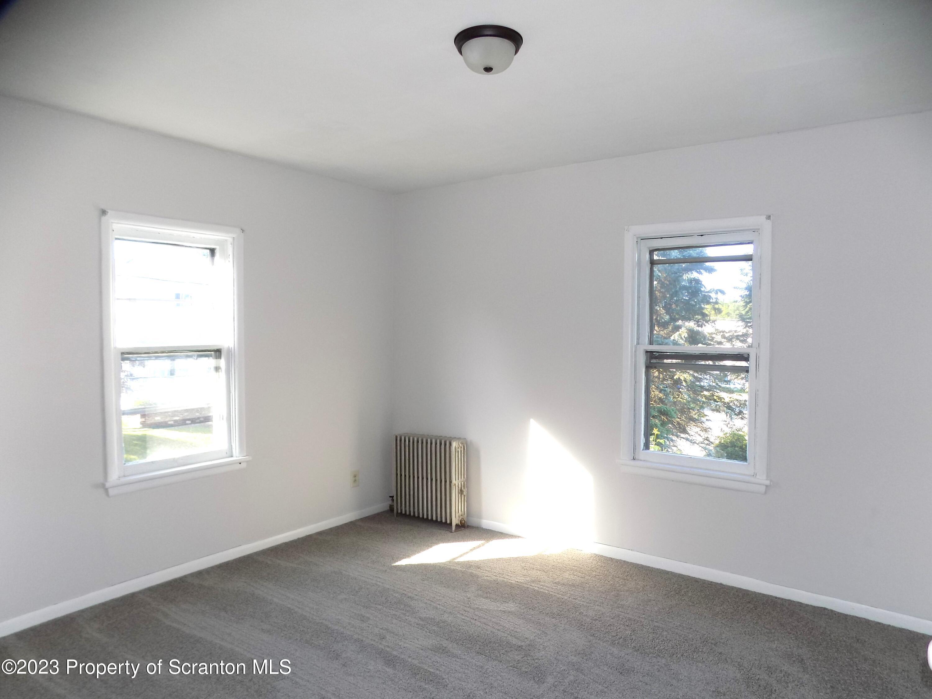 137 Pine Street, Unit 1 Throop, PA 18512 - Photo 9 of 16 an empty room with windows
