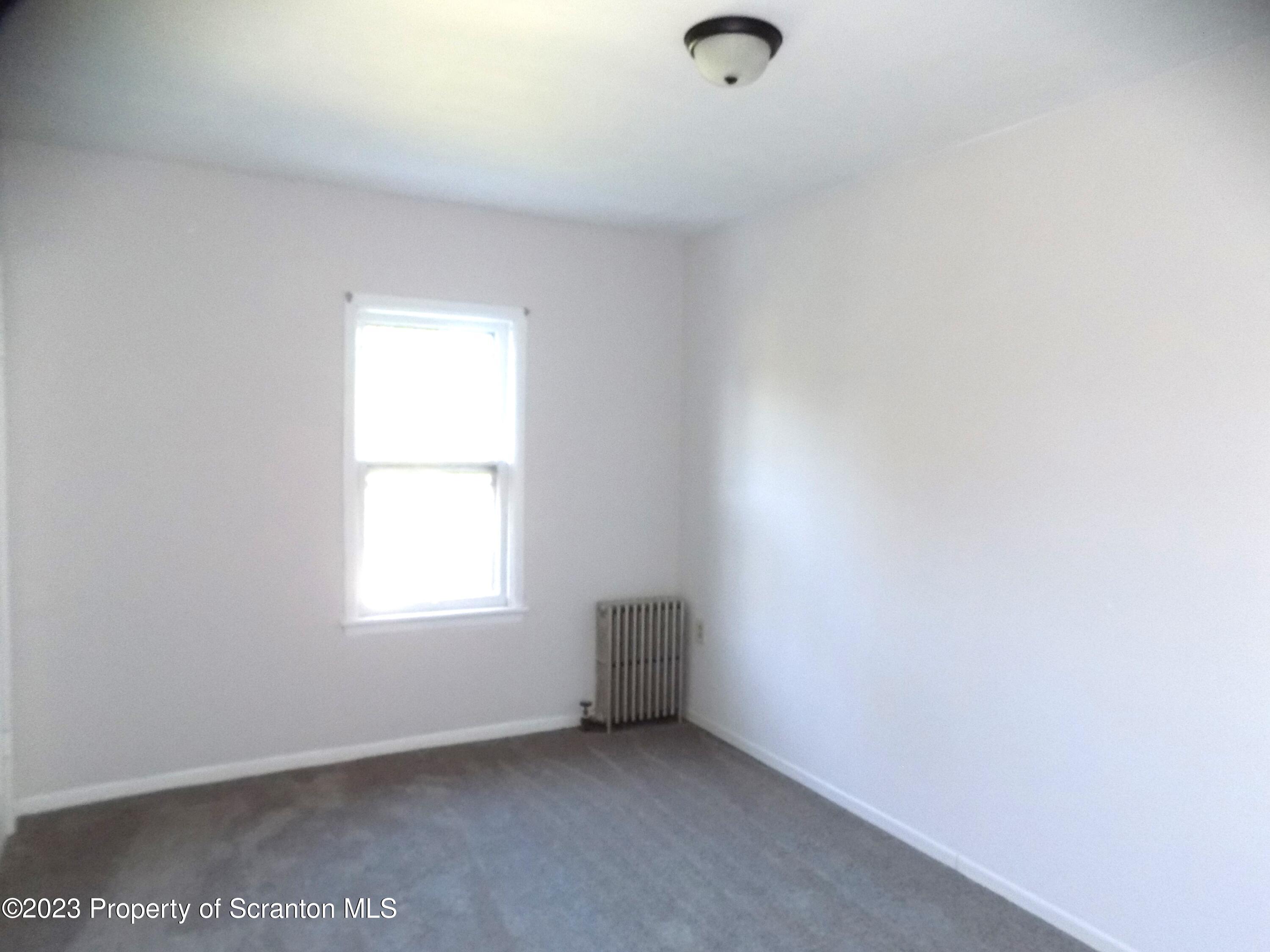 137 Pine Street, Unit 1 Throop, PA 18512 - Photo 10 of 16 an empty room with a window