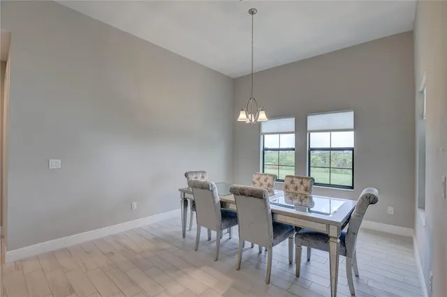 a kitchen with granite countertop a sink and white cabinets