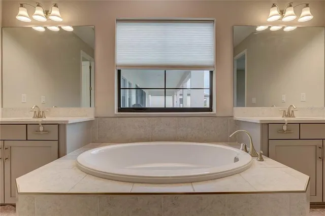 a bathroom with a granite countertop sink toilet and mirror