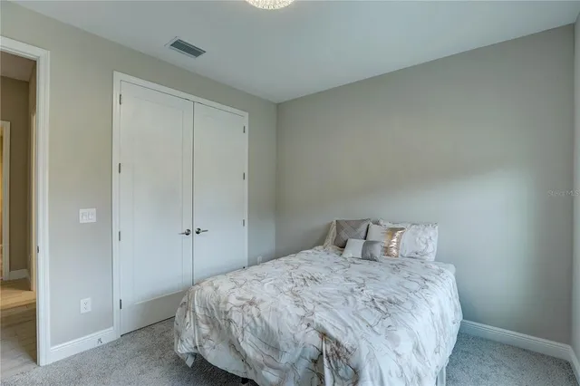 a view of a room that has a bed in it