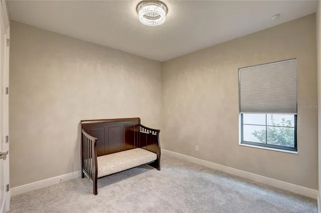 a view of a room with window and chandelier fan