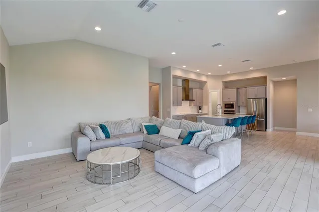 a view of a dining room with furniture wooden floor and chandelier