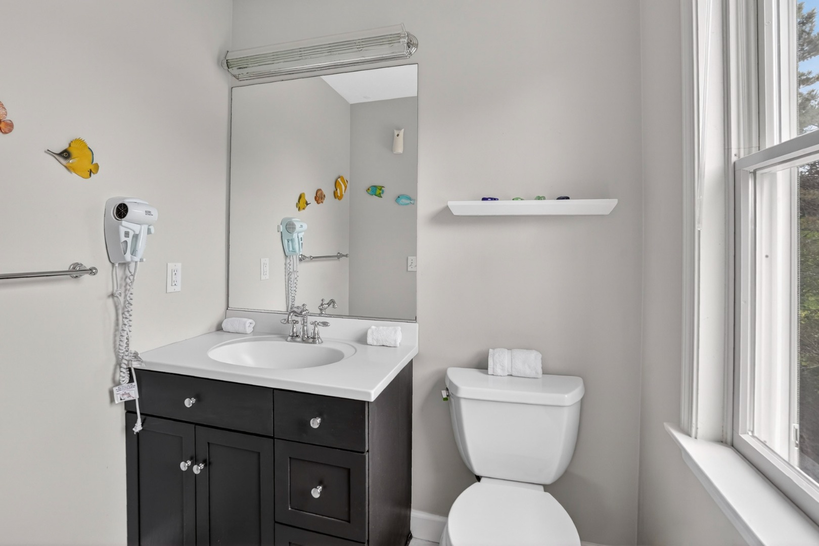 9 Thaxter Lane Edgartown, MA 02539 - Photo 18 of 53 a bathroom with a sink a toilet and mirror