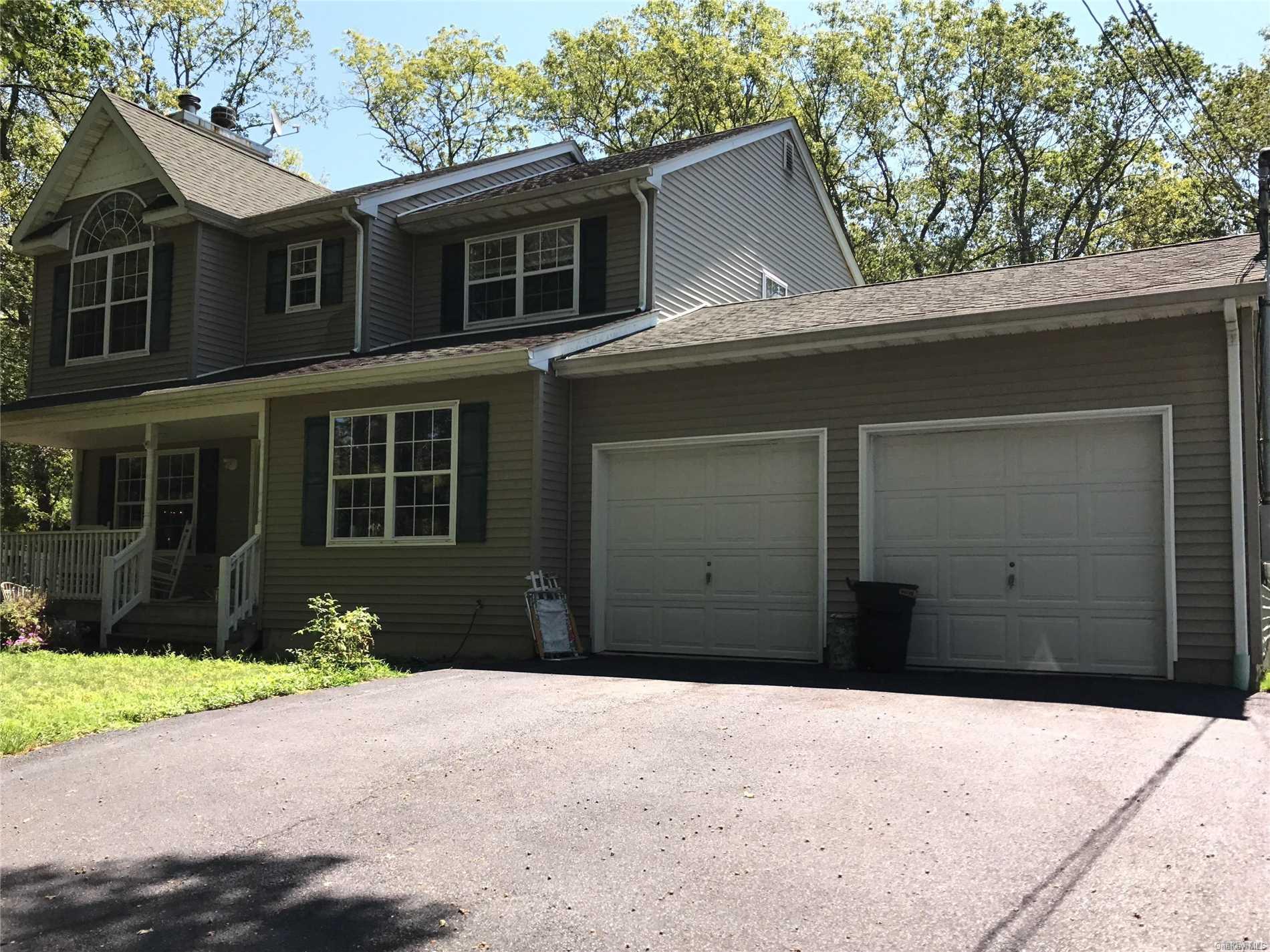 626 Middle Country Road Ridge, NY 11961 - Photo 1 of 1 a front view of a house with a yard and garage