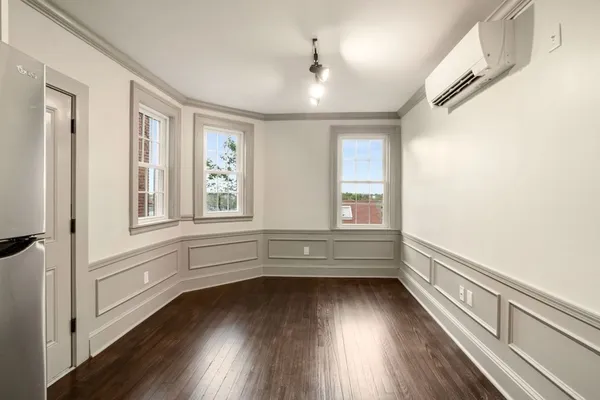 a view of lot with window and wooden floor