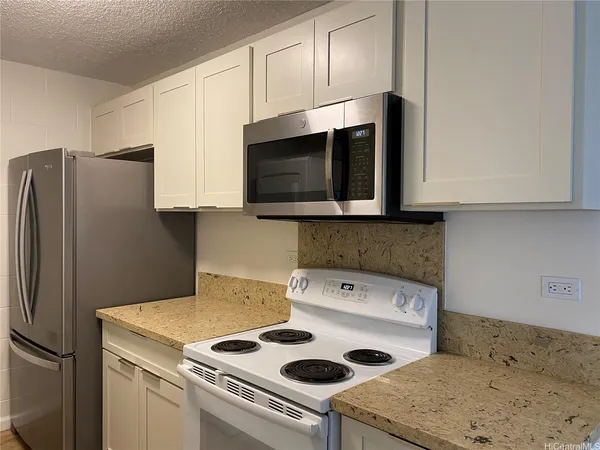 a kitchen with a sink a stove and refrigerator