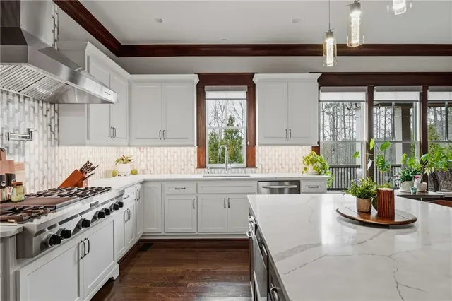 a bathroom with a granite countertop sink a large mirror a and shower