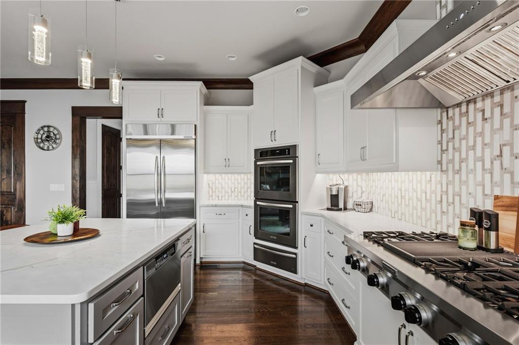 263 Hanson Way Northwest Marietta, GA 30064 - Photo 26 of 84 a kitchen with granite countertop a stove a sink and a refrigerator