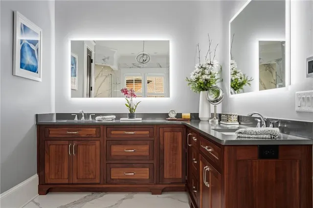 a kitchen with stainless steel appliances granite countertop a stove a sink dishwasher a dining table and chairs with wooden floor