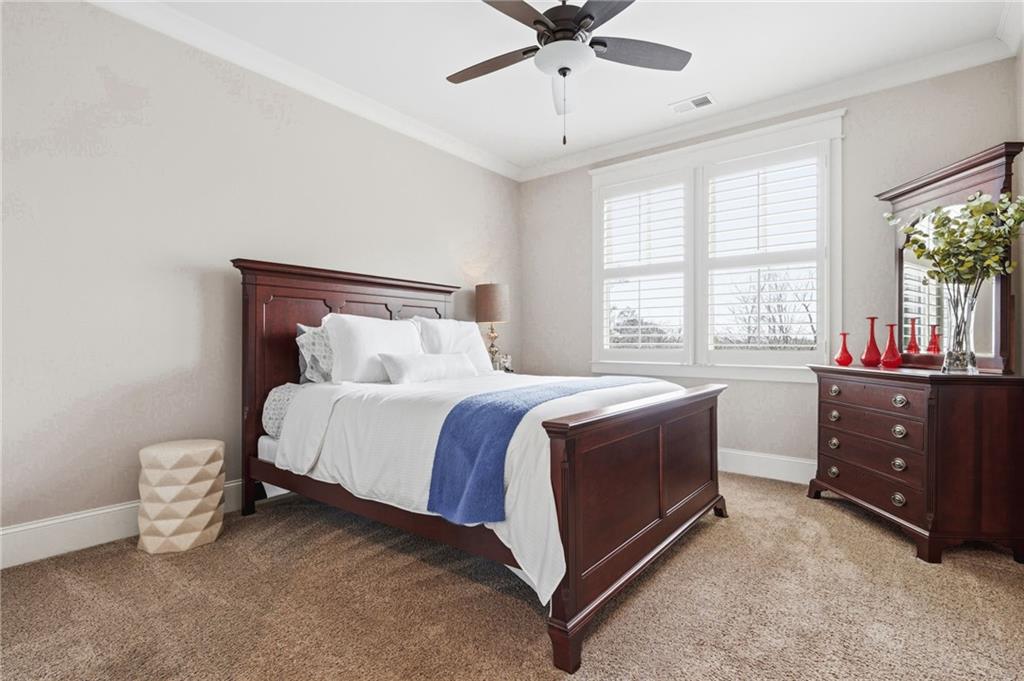 263 Hanson Way Northwest Marietta, GA 30064 - Photo 40 of 84 a spacious bedroom with a bed and a chandelier