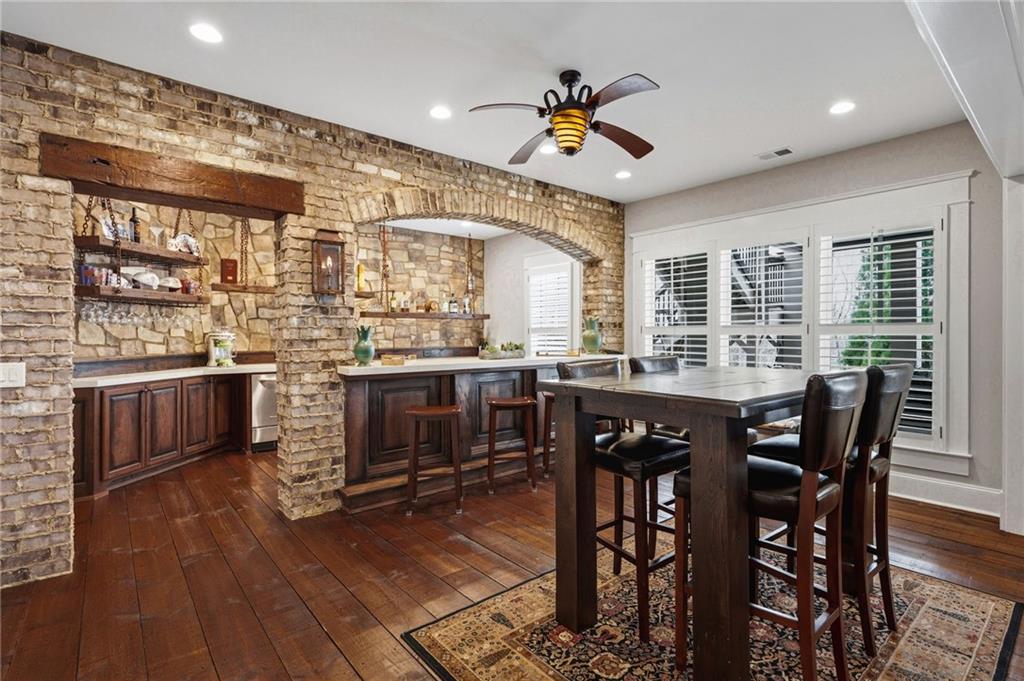 263 Hanson Way Northwest Marietta, GA 30064 - Photo 49 of 84 a kitchen with stainless steel appliances granite countertop a stove a sink dishwasher a dining table and chairs with wooden floor