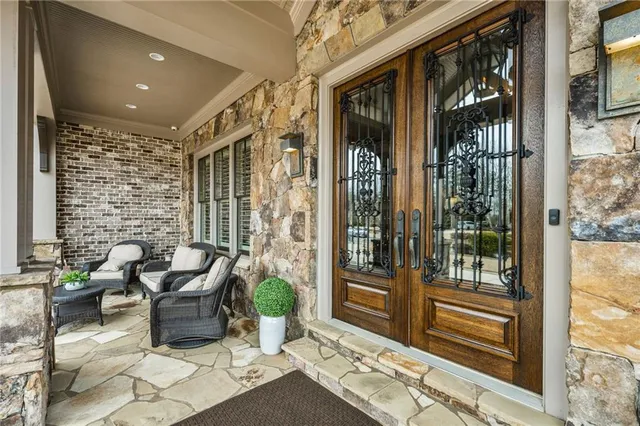 a living room with furniture and a floor to ceiling window