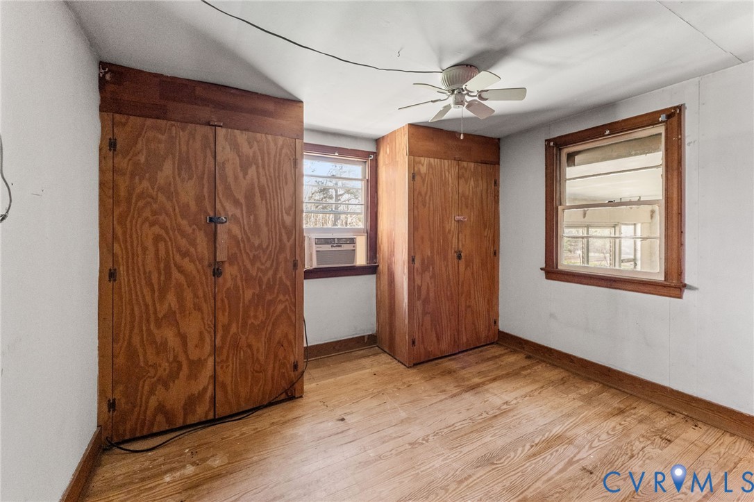 19161 Hollowing Creek Road Beaverdam, VA 23015 - Photo 16 of 27 an empty room with wooden floor fan and windows