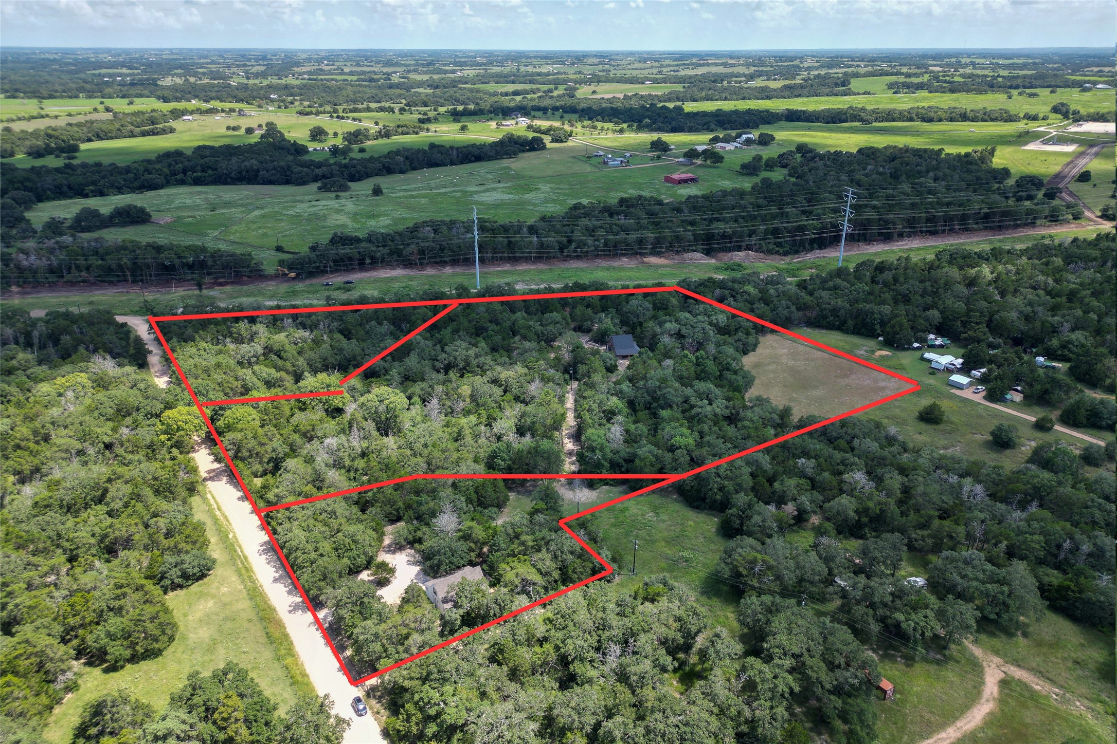 4937 Wolff Road Round Top, TX 78954 - Photo 30 of 31 This aerial view highlights the home and its expansive 2.838-acre property, outlined in red.