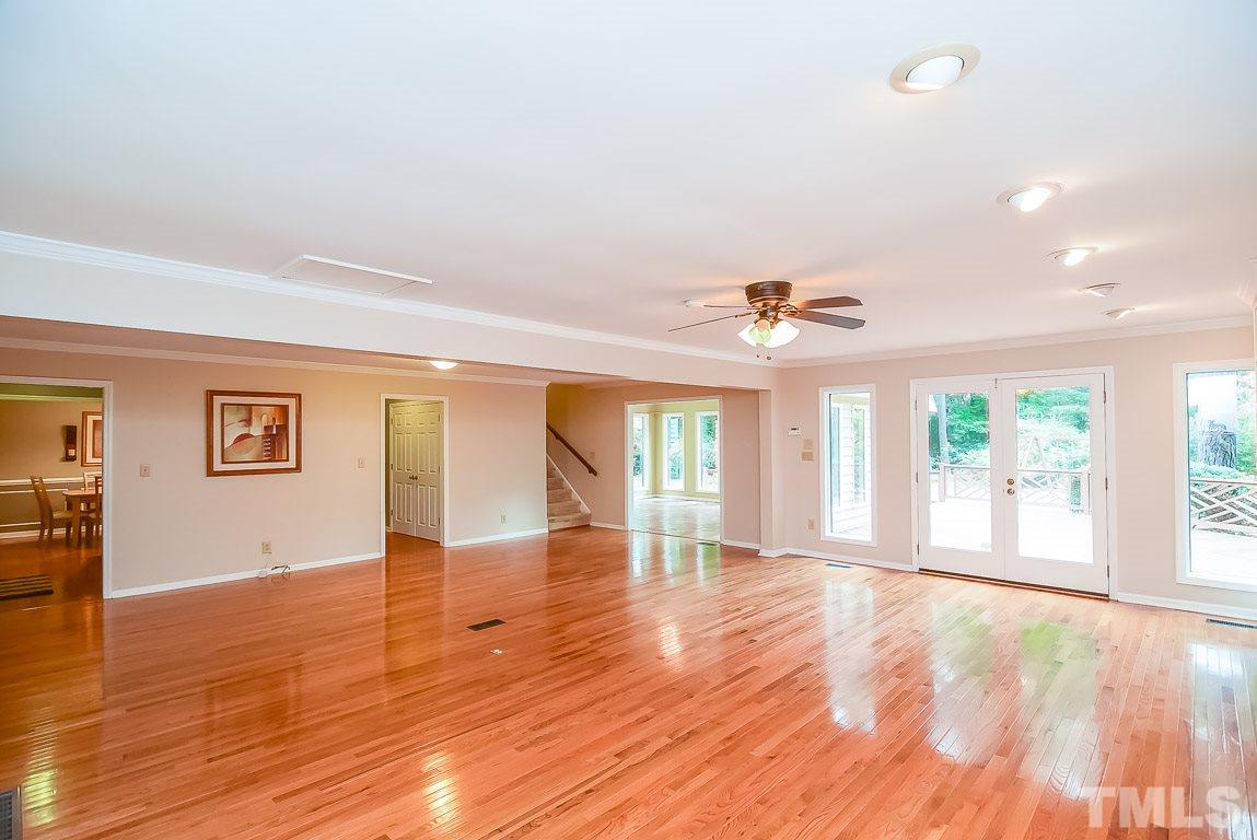 12200 Victory Church Road Raleigh, NC 27613 - Photo 14 of 25 a view of an empty room with window and wooden floor