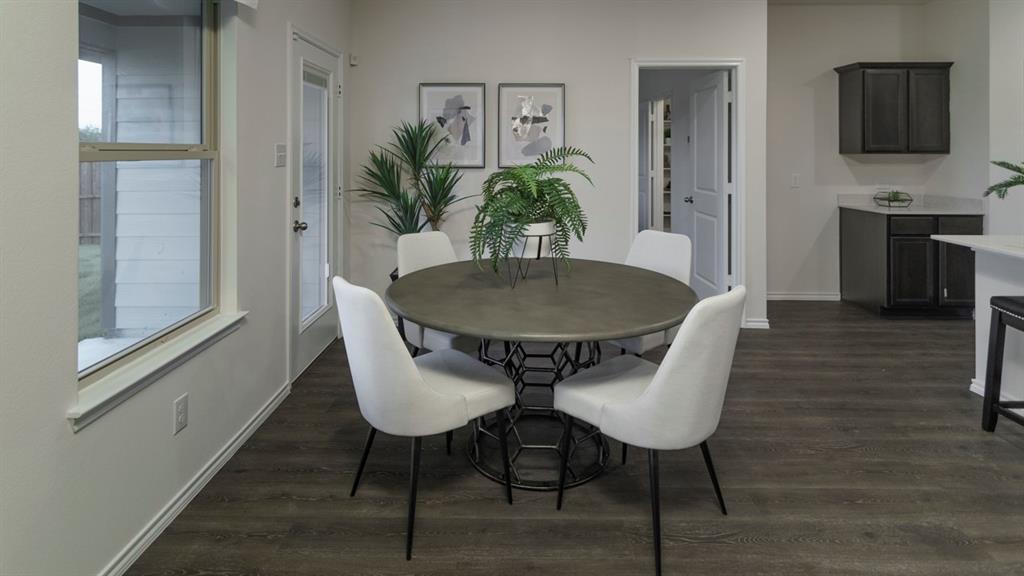 3100 Charleston Drive Ennis, TX 75119 - Photo 21 of 23 Dining area featuring wood-finish flooring, a contemporary door with a window pane, and a large window