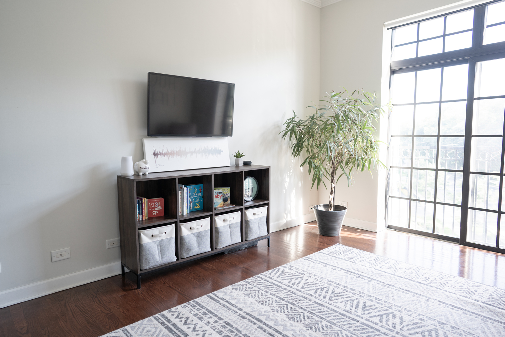 6421 West Touhy Avenue, Unit 4B Chicago, IL 60646 - Photo 17 of 24 a living room with furniture and a flat screen tv