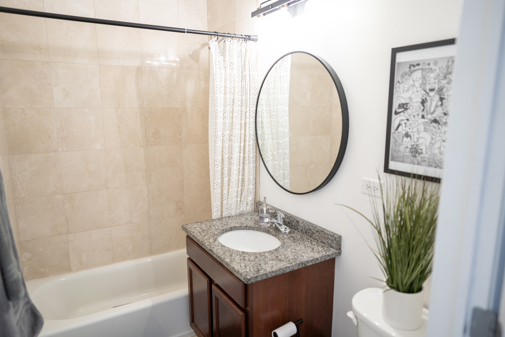 6421 West Touhy Avenue, Unit 4B Chicago, IL 60646 - Photo 18 of 24 a bathroom with a granite countertop sink toilet and a mirror