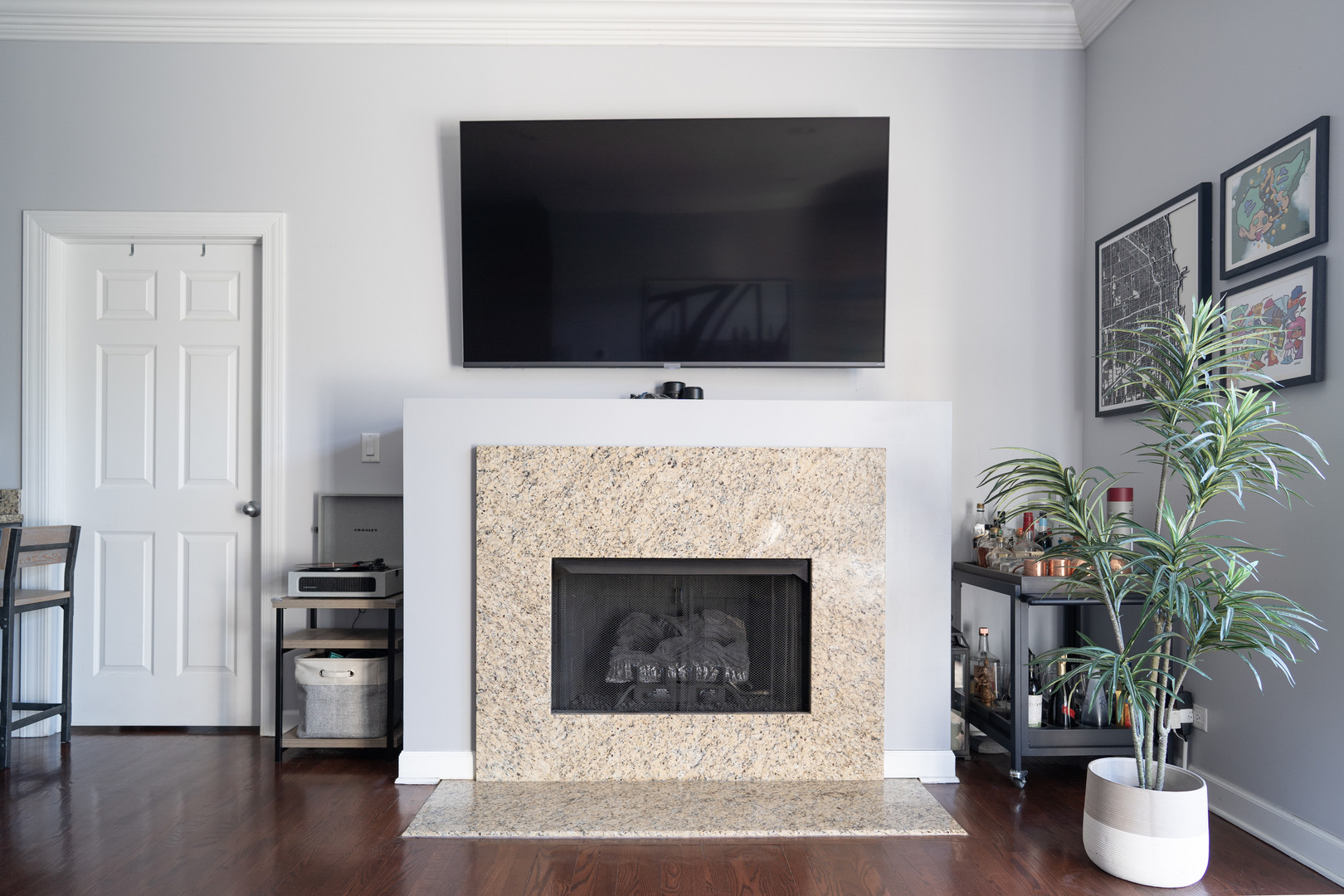 6421 West Touhy Avenue, Unit 4B Chicago, IL 60646 - Photo 5 of 24 a living room with a fireplace and a flat screen tv