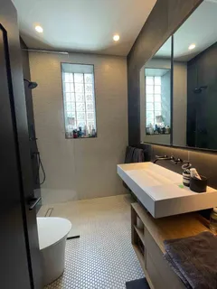 a bathroom with a sink a toilet and mirror