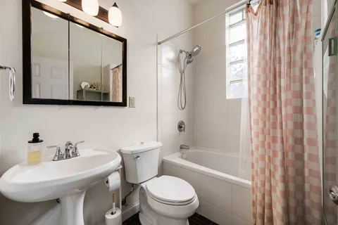 a bathroom with a toilet a sink and a bathtub