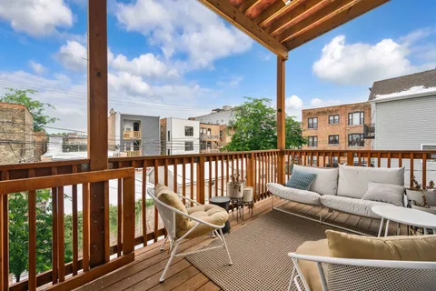 a view of a balcony with furniture