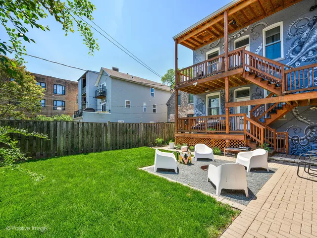 a front view of a house with a yard table and chairs