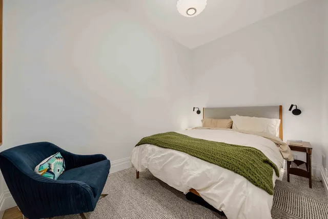 a bedroom with a bed and a couch