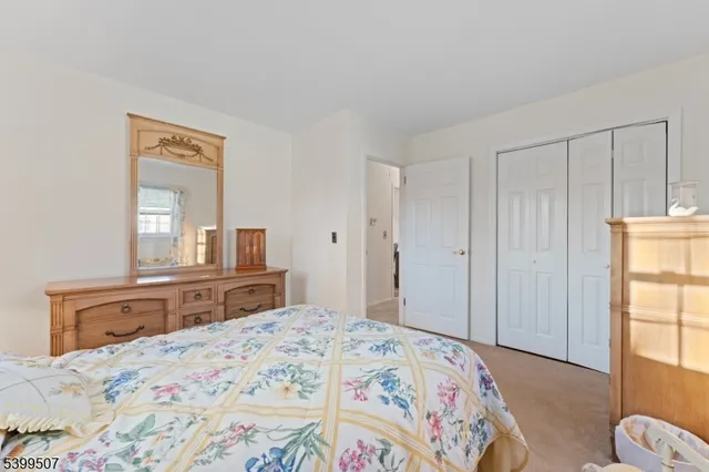 a bedroom with a bed and a dresser in it