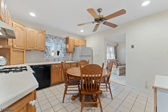 a kitchen with a dining table cabinets appliances and a window