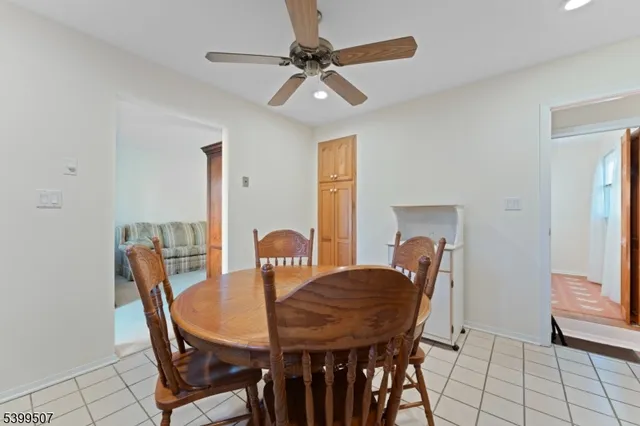 a view of a dining room with furniture and a chandelier