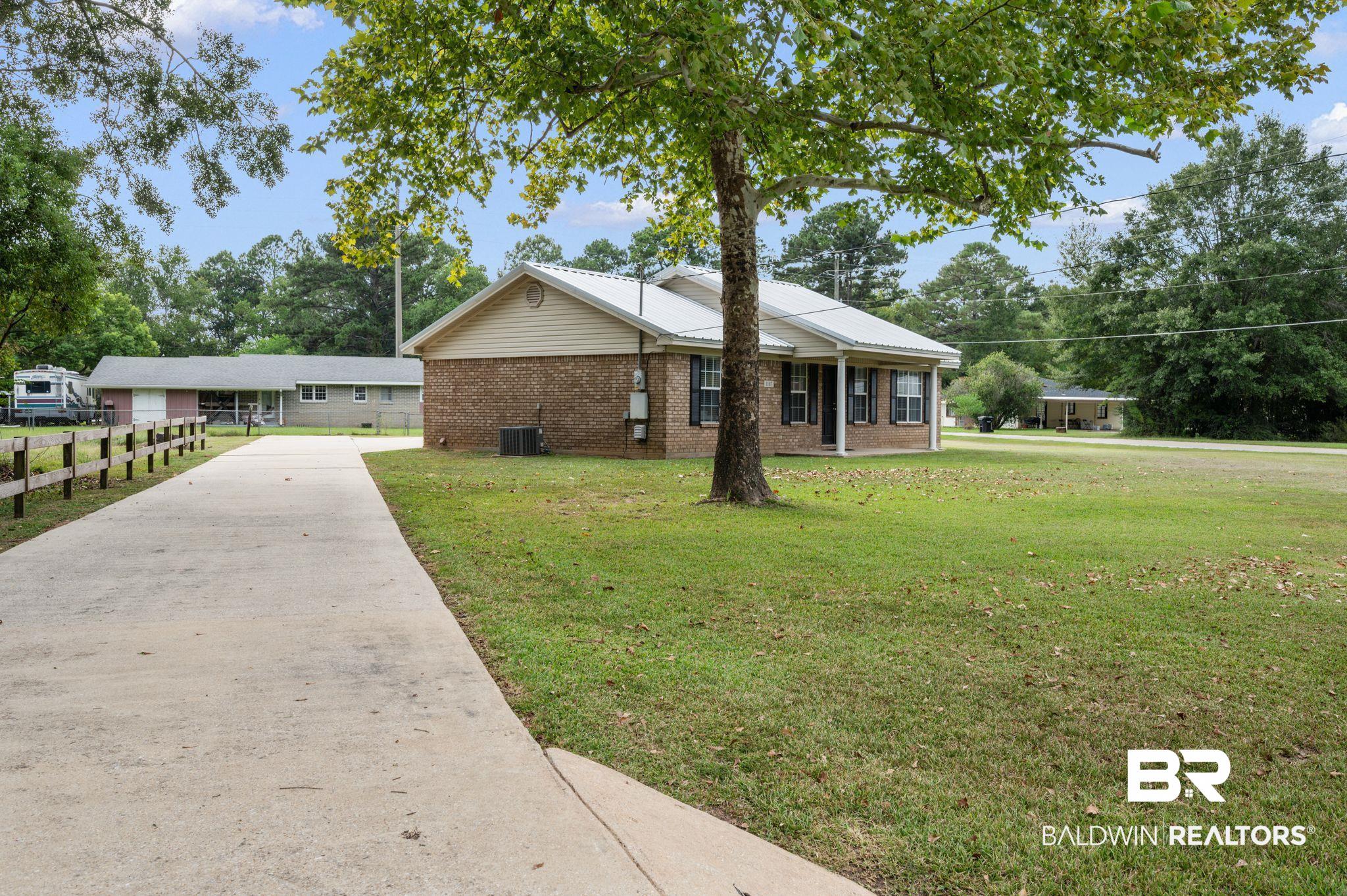 1107 North Oak Street Loxley, AL 36551 - Photo 22 of 40 View of front of home with a front lawn and central air condition unit