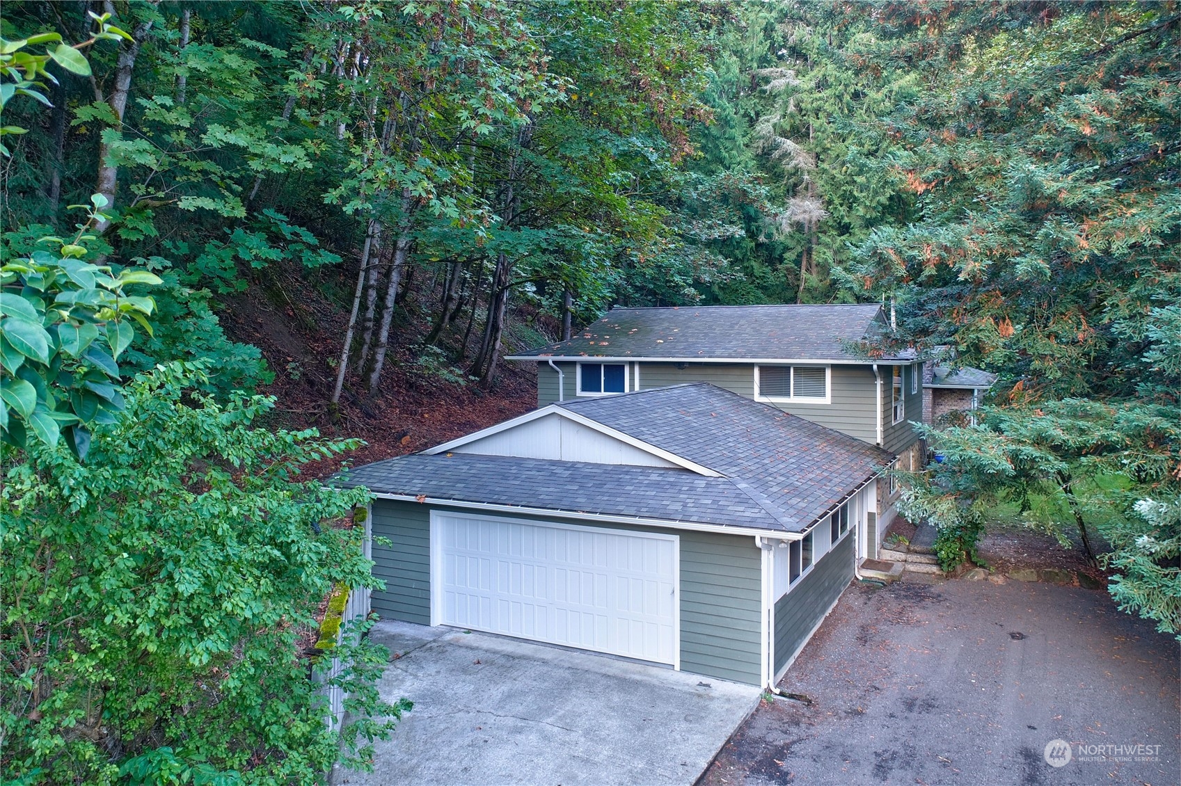 17802 Southeast Jones Road Renton, WA 98058 - Photo 1 of 38 a front view of a house with a garden