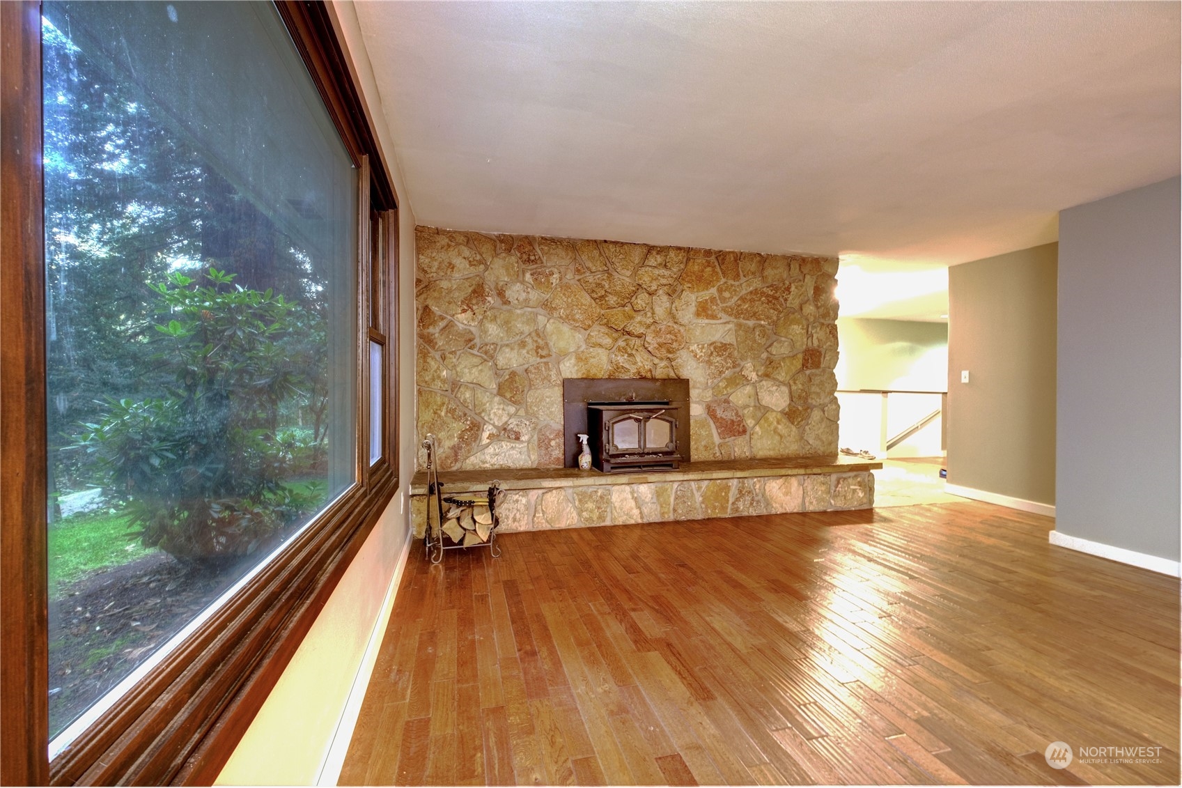 17802 Southeast Jones Road Renton, WA 98058 - Photo 13 of 38 a view of a room with wooden floor and a floor to ceiling window