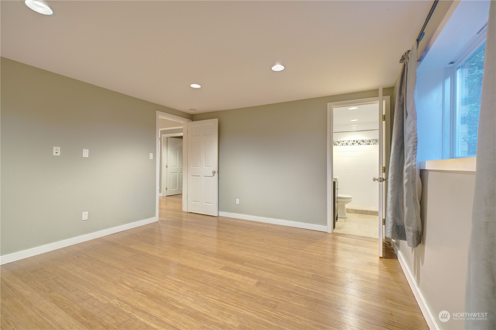 17802 Southeast Jones Road Renton, WA 98058 - Photo 26 of 38 a view of an empty room with wooden floor and a window